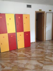 a room with colorful lockers on the wall at Hostal Ideal Sants in Barcelona