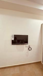 a flat screen tv on a white wall at Hotel Ashoka Kokan Ganpatipule in Ganpatipule