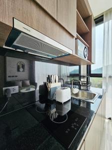 a kitchen with a counter top with a sink and aounter at patong see view condo in Patong Beach