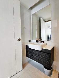a bathroom with a sink and a mirror at patong see view condo in Patong Beach +6 photos
