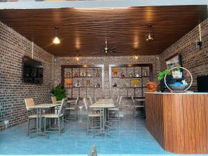 a restaurant with tables and chairs and a brick wall at Your Home in Vũ Lâm