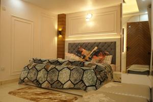 a bedroom with a large bed with a head board at kailash keep in Haridwār