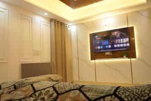 a hospital room with a tv on the wall at kailash keep in Haridwār