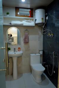 a bathroom with a toilet and a sink and a mirror at kailash keep in Haridwār +12 photos