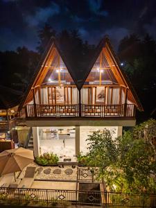 a house with a lit up facade at night at The Pyramid Ubud River Villas in Gianyar