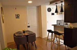 a kitchen with a table and chairs in a room at Cesar's Apartment - Los Laureles in Lima