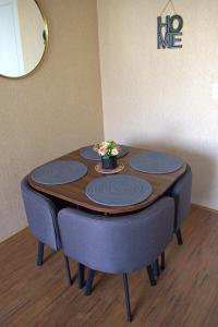 a table with four chairs and a bowl of flowers on it at Cesar's Apartment - Los Laureles in Lima
