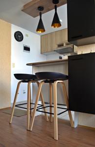 a kitchen with two black chairs and a table at Cesar's Apartment - Los Laureles in Lima +31 photos