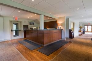 a lobby with a bar in the middle of a room at Winwood Inn & Condominiums in Windham