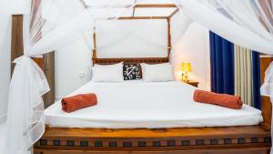 two beds in a room with a canopy bed at Sunrise Cottage in Sigiriya +70 photos