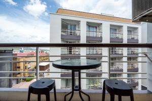 a table and two chairs on a balcony with a building at Hua Hin Condo B - Maysa & Hin Nam in Hua Hin