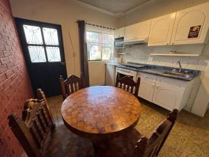 a kitchen with a wooden table with chairs and a sink at Hotel Bungalows La Era in Ixtapan de la Sal +69 photos