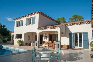 a villa with a patio and a swimming pool at Le Mas Pinède in Lorgues