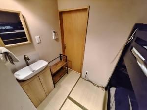a small bathroom with a sink and a toilet at Sakae Guesthouse in Nagoya +37 photos