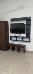 a flat screen tv sitting on a wall at Riyanhouse in Pūrnānkuppam
