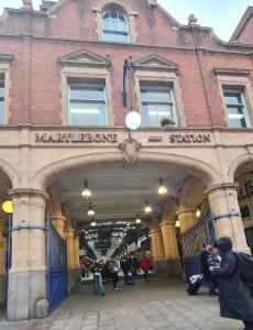 a train station with people walking through a building at Bliss Home in Harrow on the Hill