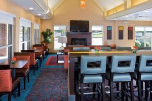 a restaurant with chairs and tables and a bar at PrimeStay Extended Suites by IHG in Madison