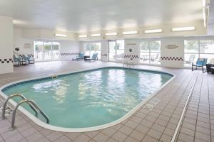 a large swimming pool in a hotel room at PrimeStay Extended Suites by IHG in Madison