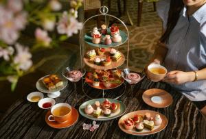a table topped with plates of food and cups of coffee at Mandarin Oriental, Tokyo in Tokyo