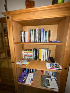 a book shelf filled with books and magazines at 4 Bedroom House By Travel Lets Holiday Homes Downings With Beautiful Ocean View in Downings