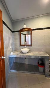 a bathroom with a sink and a mirror at Yoga bale house3 in Padangbai