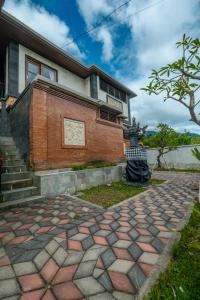 a house with a brick walkway in front of it at Arsyana Villa in Sidemen