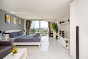 a bedroom with a bed and a living room at Hua Hin Condo C - Maysa & Hin Nam in Hua Hin