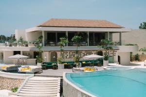 a hotel with a swimming pool in front of a building at Vanara Resort and Spa in Uluwatu