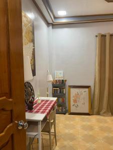 a room with a table and a book shelf at Naybe's Room rentals in Dapa