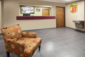 a waiting room with a chair and a cash register at Super 8 by Wyndham Dwight in Dwight