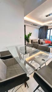 a living room with a glass table and a couch at 3BR family friendly Apartment at The Elements Ampang Kuala Lumpur in Kuala Lumpur