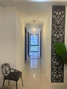 a hallway with a chair and a window at 3BR family friendly Apartment at The Elements Ampang Kuala Lumpur in Kuala Lumpur +51 photos