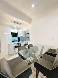 a living room with a glass table and chairs at 3BR family friendly Apartment at The Elements Ampang Kuala Lumpur in Kuala Lumpur