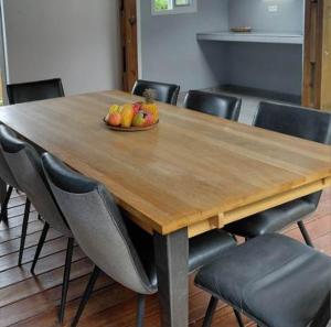 a wooden table with a bowl of fruit on it at Ti Kaz Salazie 2 in Salazie +4 photos