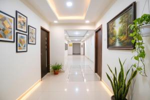 a corridor in a building with paintings on the walls at FabHotel Arsh Executive Inn in Mumbai