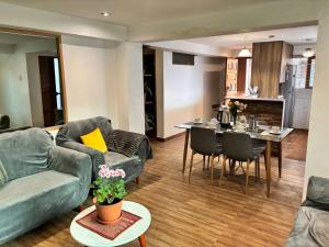 a living room with a couch and a table at Kennedy Guest House in Cusco