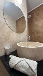 a bathroom with a large tub and a mirror at Tudor's apartment in Bucharest +51 photos