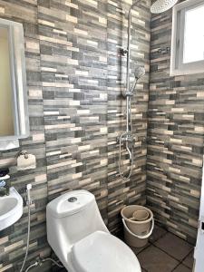 a bathroom with a shower and a toilet and a sink at Casa Solara in General Santos +14 photos