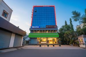 a building with a sign on top of it at FabHotel Golden Heights in Hinjewadi