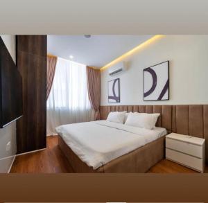 a bedroom with a large bed and a television at Home helpers in Lagos