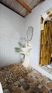 a bathroom with a toilet and a sink at Villa Lakdu in Sorongjukung