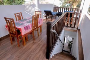 a balcony with a table and chairs on it at Arunella Beach Villa in Tangalle