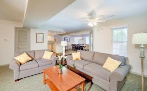 a living room with two couches and a table at Beachwoods Resort in Kitty Hawk