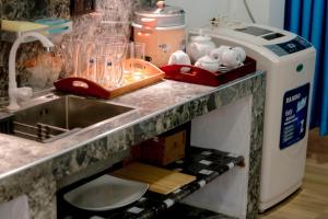 a kitchen counter with a sink and a counter top with a mixer at Arunella Beach Villa in Tangalle +24 photos