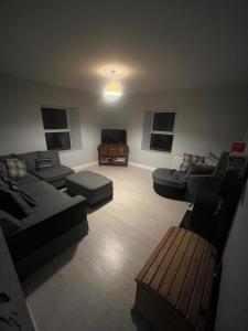 a large living room with couches and a tv at The Rathmore House in Roscommon