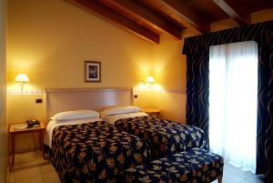 Ένα ή περισσότερα κρεβάτια σε δωμάτιο στο Hotel Ristorante Novecento