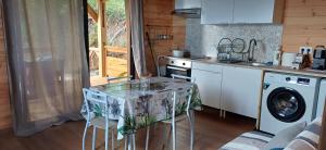 a kitchen with a table with a table cloth on it at Les chalets de la mare in Entre-Deux