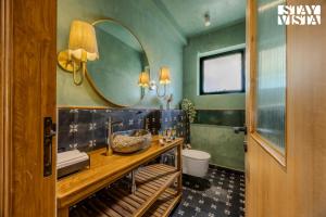 a bathroom with a sink and a mirror at StayVista at Casa Roma - Private Pool in Siolim