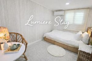 a room with a bed and a sign that reads furniture stay at 루미에르스테이 in Ŭijŏngbu-yŏk