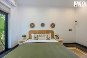 a bedroom with a large bed and a window at StayVista at Casa Roma - Private Pool in Siolim +33 photos